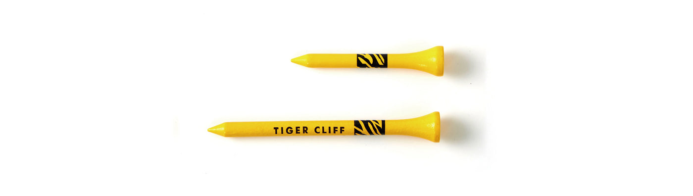 Two yellow Tiger Cliff golf tees on a white background.