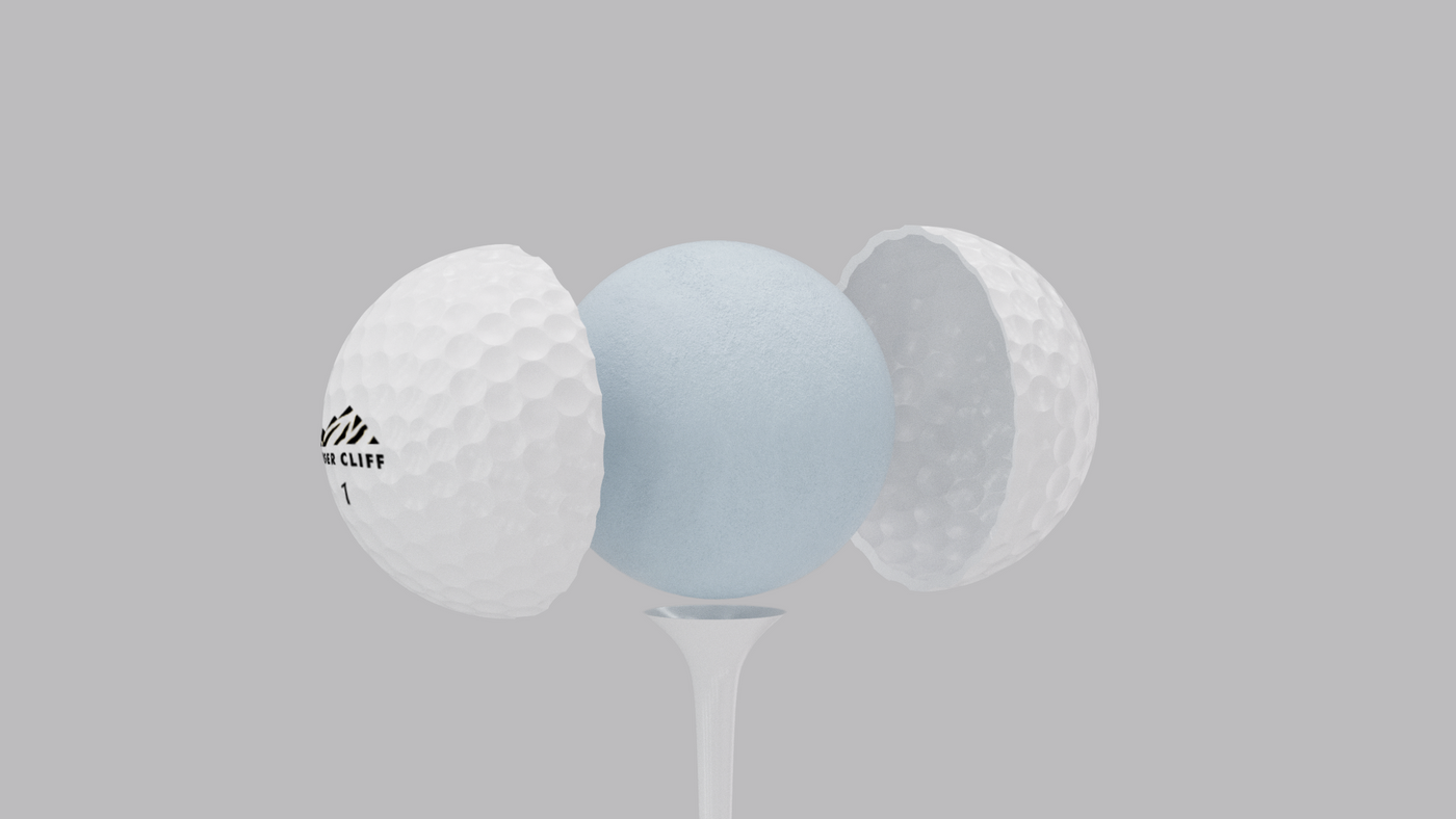 Exploded view of a golf ball on a tee, revealing the inner core.