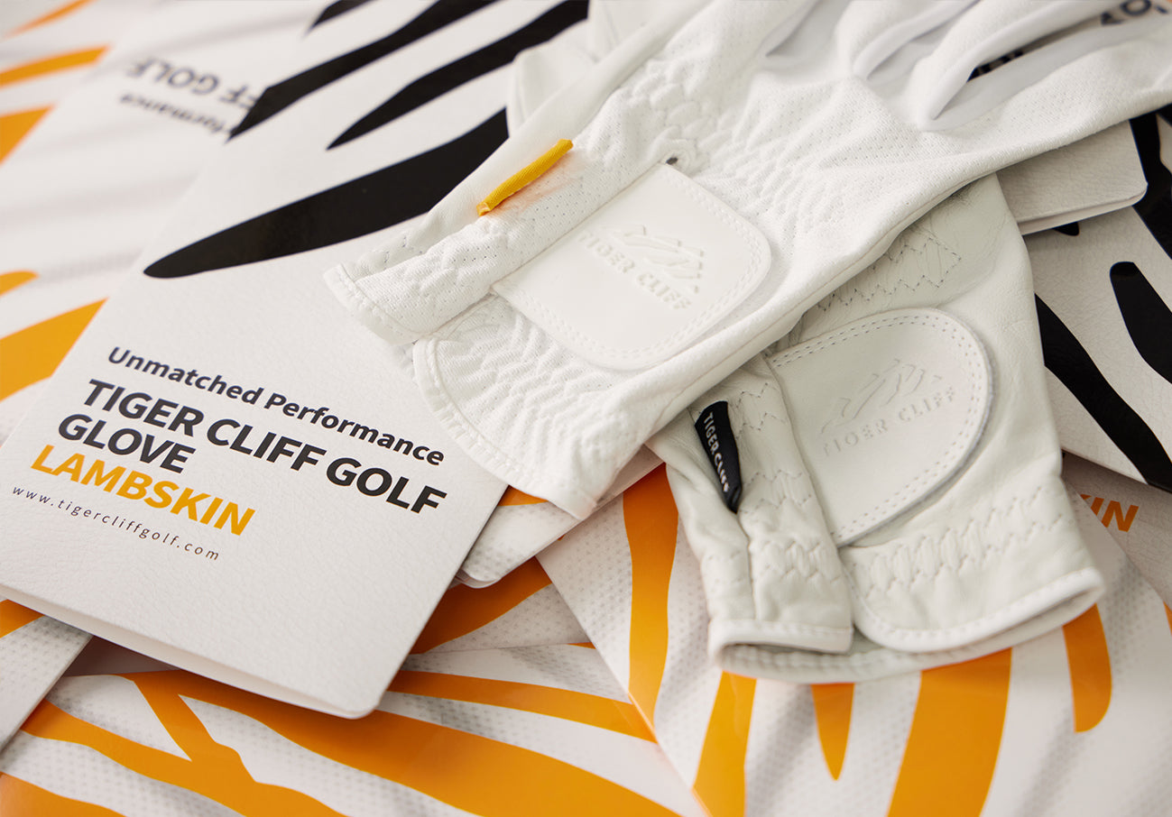 Close-up of white TIGER CLIFF GOLF Lambskin gloves.