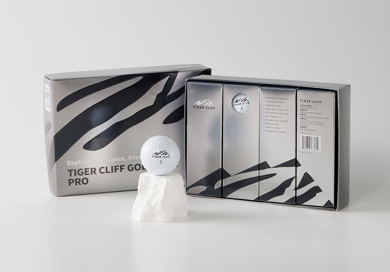 Tiger Cliff Pro golf balls & packaging. One ball sits on a white rock.