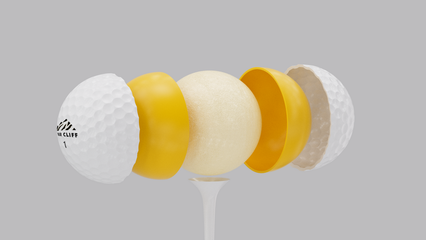 Exploded view of a golf ball showing its layers on a tee.