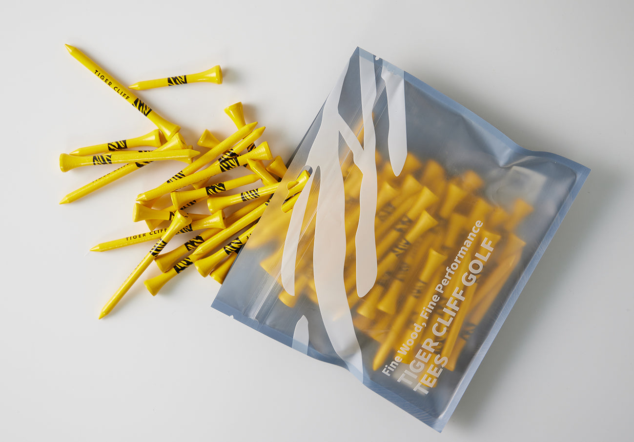 Yellow TIGER CLIFF golf tees spilling from a bag.