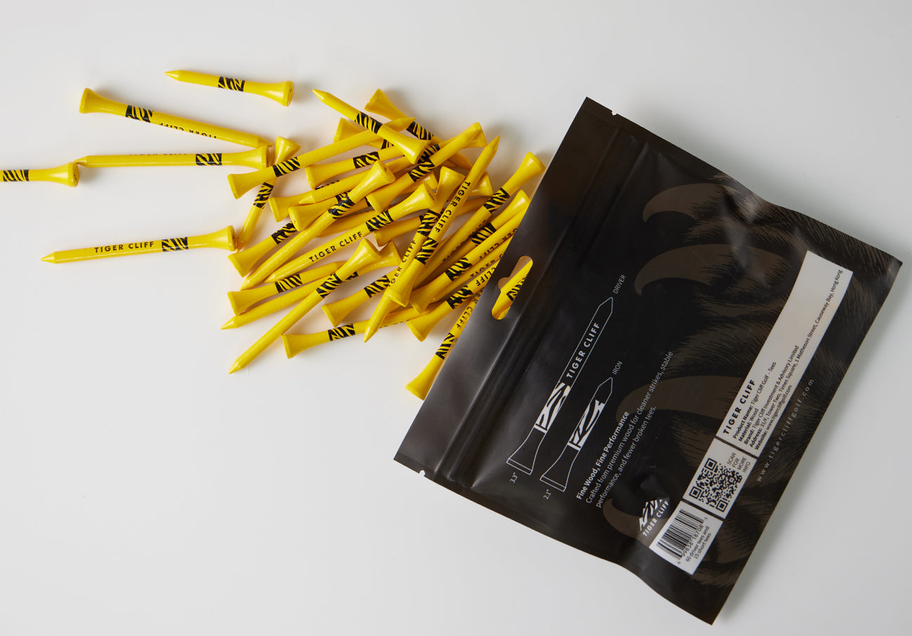 Yellow Tiger Cliff golf tees spilling from black packaging.