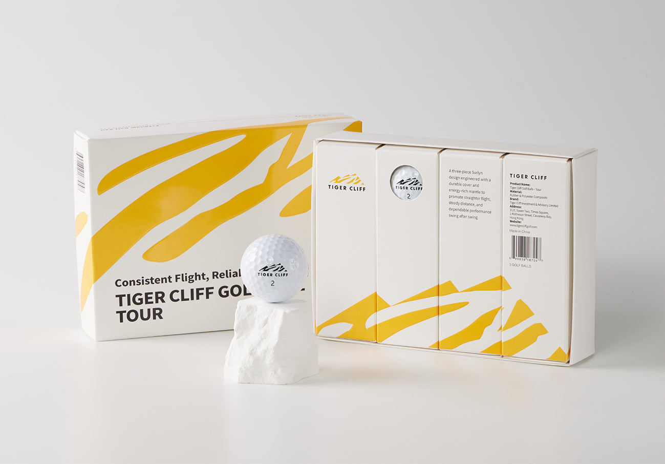 Tiger Cliff Golf Tour balls and packaging, with a golf ball on a small white block.