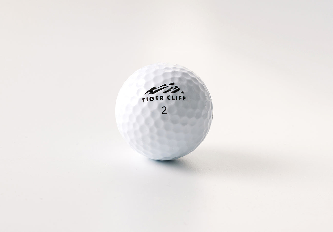 Close-up of a white Tiger Cliff golf ball with the number 2.