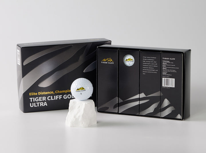 Tiger Cliff Golf Ultra balls with packaging. One ball sits on a white rock.