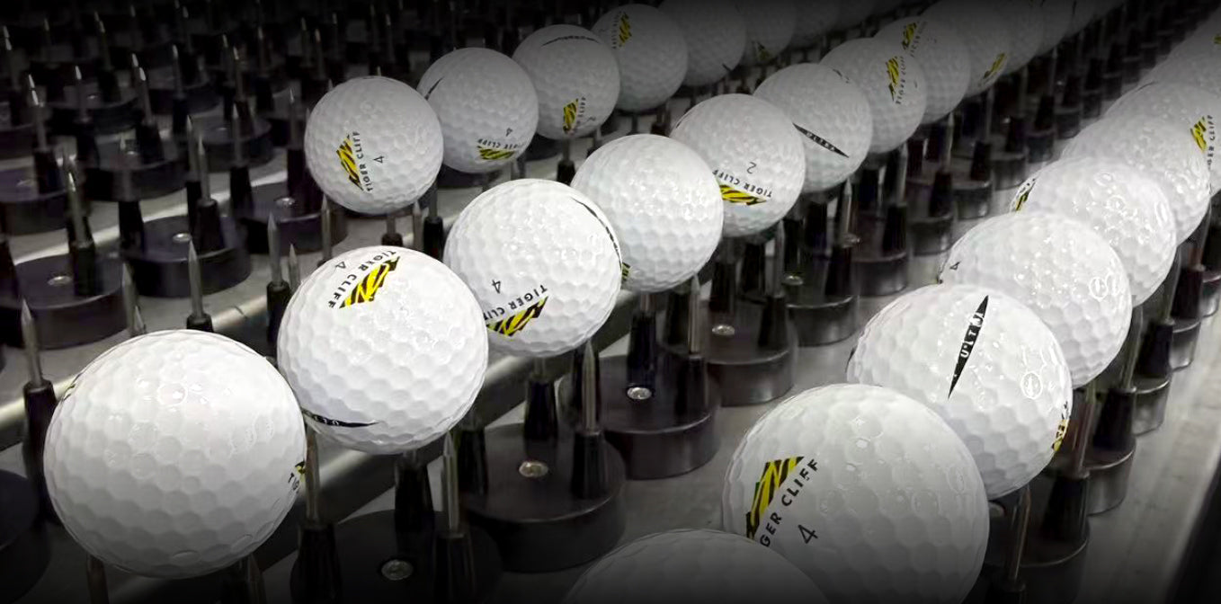 Rows of Tiger Cliff golf balls on stands.