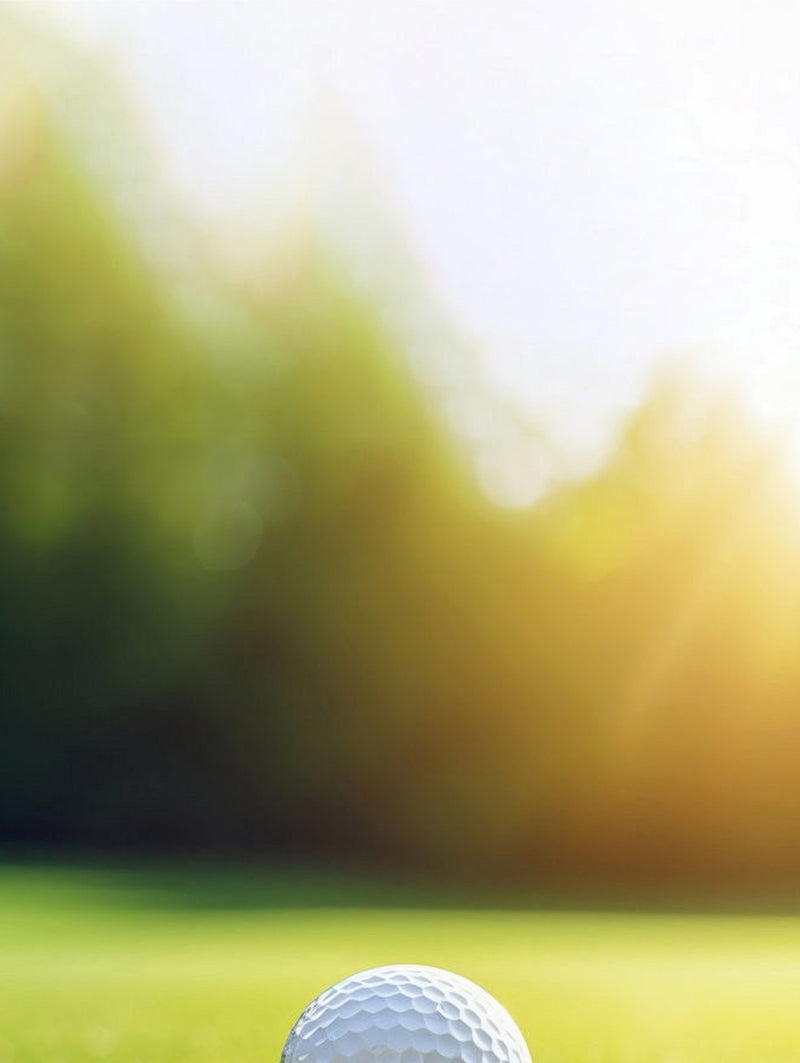 Golf "balls.jpg" on green grass with bright sunlight.